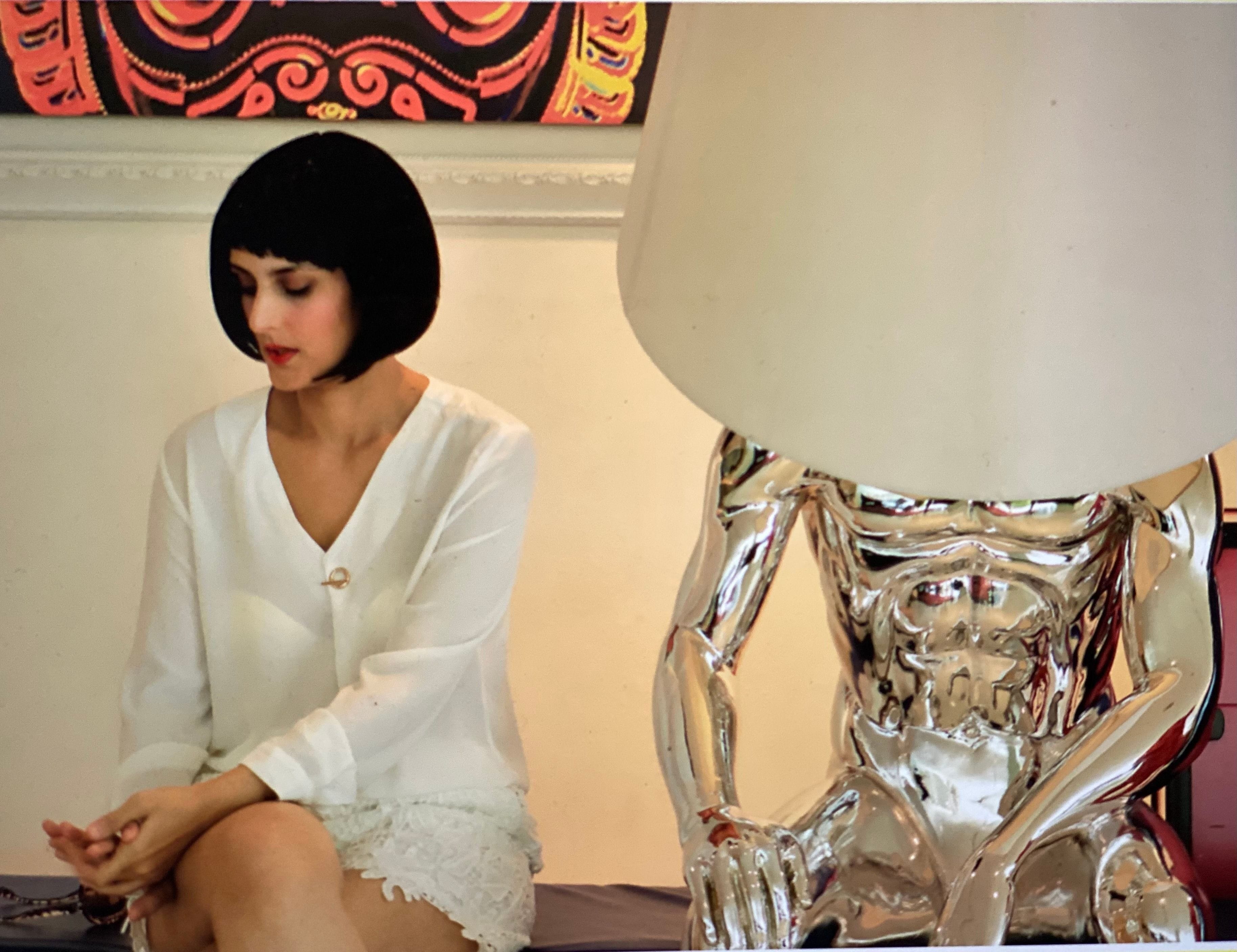 Tulip Joshi in Short Hair Sitting Alongside a Silver Male Mannequin